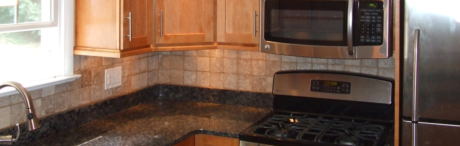 remodeled kitchen with new kitchen cabinets, countertops and backsplash