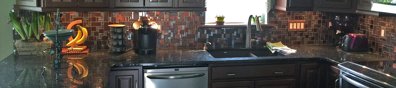 remodeled kitchen cabinets, back splash, and countertops